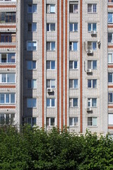 Multi-storey residential building under the sun rays on a summer day.
