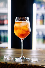 Colorful cocktail with gin and tonic in wine glasses at the bar in a cafe or restaurant. Alcohol card for the menu.