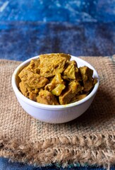 Jackfruit Gravy or Curry in a White Bowl Isolated on Burlap Fabric