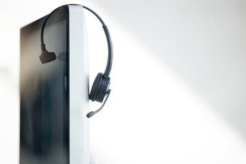 Computer, headphones and call center telemarketing background in office for contact us, virtual online consulting and sales agency. Zoom of customer service technology for receptionist communication