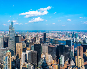 Fototapeta na wymiar New York skyline, panoramic view with skyscrapers in Midtown Manhattan with blue sky
