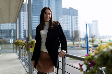 portrait of stylish modern woman in city cafe in early morning