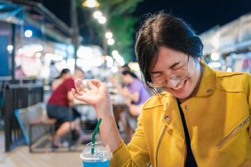Woman (LGBTQ) posing with food at thai street food