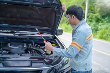 Fototapeta na wymiar Handsome mechanic. Car inspection and roadside car repair service.