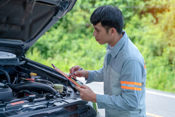 Handsome mechanic. Car inspection and roadside car repair service.