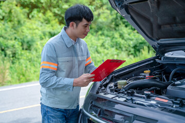 Handsome mechanic. Car inspection and roadside car repair service.