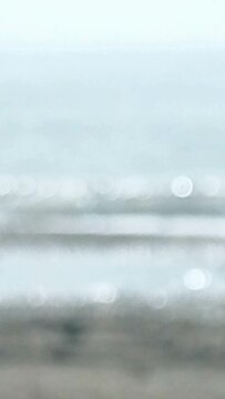 Defocused sea water lapping on shore. Abstract nature background.