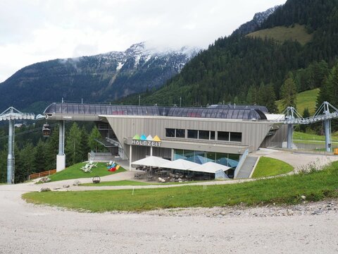 Mountain cable car and a restaurant surrounded by the beautiful Alps in a winter resort in Germany