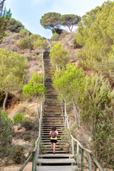 Woman with backpack climbing stairs