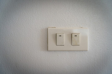 Double electric switch on cement wall in the house