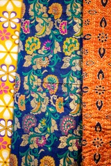 Colorful silk and cotton clothes fabric on display for women.