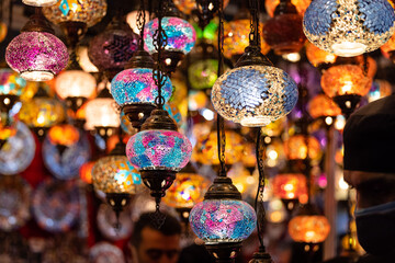 Colorful hanging lights from turkey on display for sale in Diwali fair to brighten the rooms. Artistic selective focus background.
