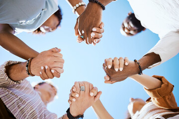 Diversity, support and people holding hands in trust and unity for community against sky background. Hand of diverse group in solidarity for united team building collaboration and teamwork success - Powered by Adobe