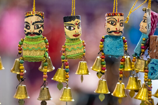 Handmade colorful Puppets or kathputli hanging with blur background. Selective focus on puppet.