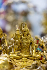 Hindu god Shiv idol made of brass with blur background. Selective focus on Shiv idol.