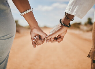Couple walking, promise and hook fingers for support, trust and love in nature outdoors. Closeup...