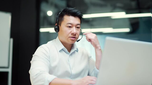 Corporate operator working in customer support service on helpline telesales. Focused man representative call center agent in wireless headset helping client with complaints using computer in office