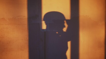 builder shadow falls on the wall silhouette. business building concept. worker in a helmet silhouette shadow falls on the wall with plaster idea concept. contractor in a helmet makes home repairs