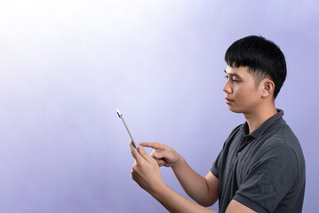 Handsome businessman shooting a photos in studios. On the purple background.