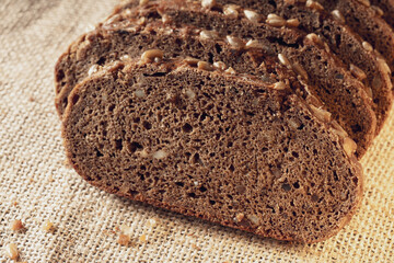 slices of cut black bread with sunflower seeds inside