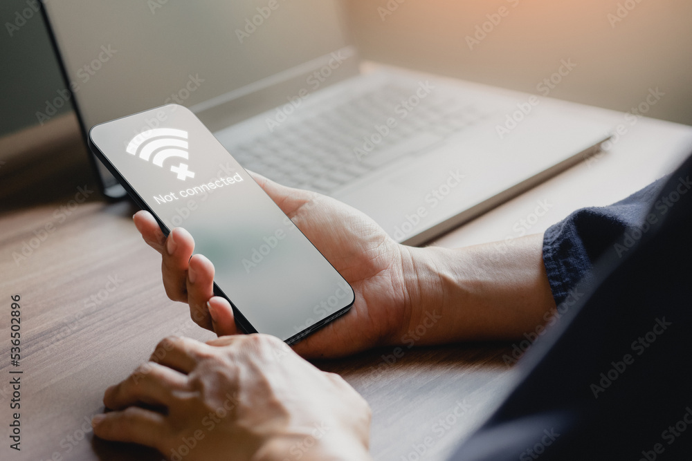 Aufkleber Man using a mobile phone to connect to wifi but wifi not connected, and waiting to loading digital business data form website, concept technology of waiting for connect to wifi by smartphone.