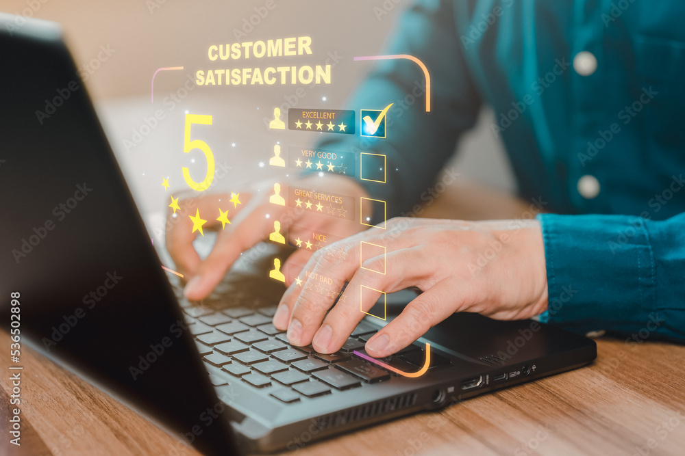 Poster businessman hand using computer laptop with popup five star icon for feedback review satisfaction se