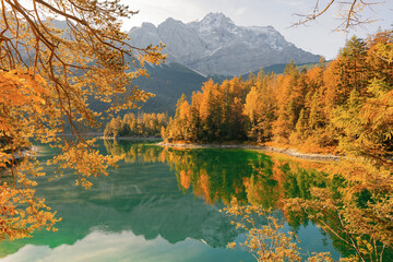Autumn colors in fall at lake Eibsee. Alpine landscape with German Alps mountain Zugspitze reflected in the Eibsee lake. Garmisch-Partenkirchen, Bavarian alps, Germany, Europe. Impressive View © Pavel Kašák