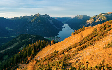 Beautiful panoramic view of the Achensee from Barenkopf rock during sunset in autumn with dramatic sky. Tyrol, Austria in it's beauty surrounded with mountains - obrazy, fototapety, plakaty