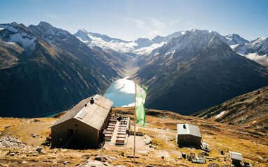 Breathtaking panoramic view on the Olperer mountain hut. Valley with Schlegeis reservoir at the...