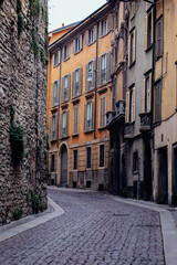 Paved road with appartment buildings and architecture in Bergamo, Italy