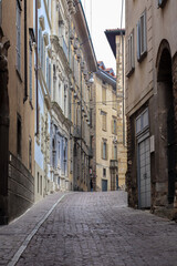 Paved road with appartment buildings and architecture in Bergamo, Italy