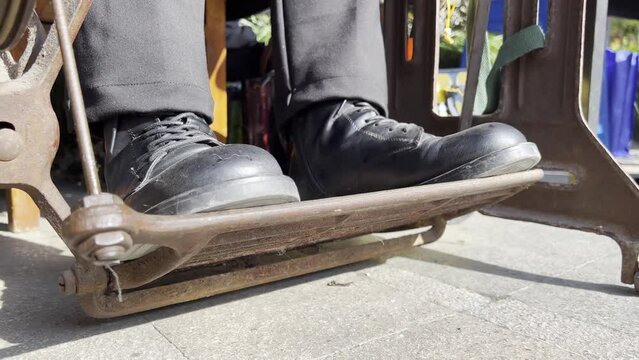 feets on pedal of sewing machine