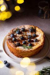 lush sponge cake with blueberries, powdered sugar and rosemary