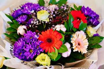 Obraz na płótnie Canvas view from above on a bouquet of red, yellow, white and purple delicate flowers. 