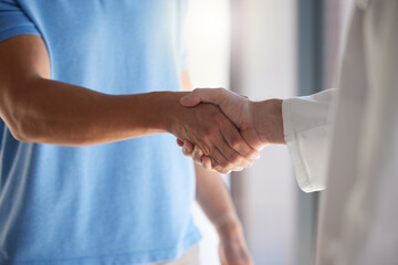Handshake, trust and respect with a patient and medical worker or doctor shaking hands, greeting or introduction during consultation. Closeup of men with thank you gesture or welcome, agree or greet - obrazy, fototapety, plakaty