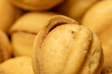 Homemade cookies in the shape of a nut with a sweet filling. Close-up, selective focus.