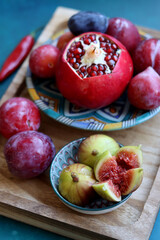 Colorful still life with fresh fruit. Pomegranate close up photo. Israeli food on a table. Eating fresh concept. 