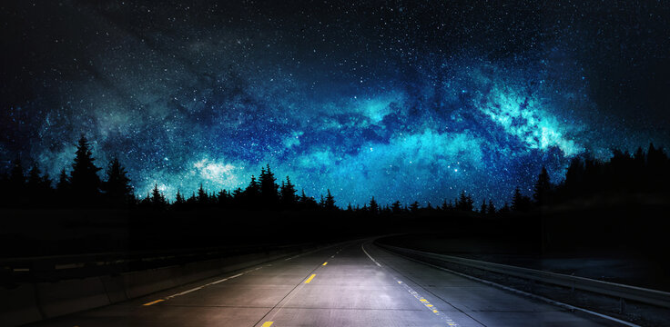 dark night road through forest and starry sky