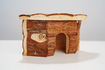 a small wooden house for a hamster and a mouse on a white background. 