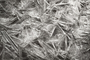 The texture of the ice surface. Winter background, festive background in the form of ice crystals, in monochrome color. 