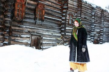 Fototapeta premium young girls in traditional costumes of the Russian north in winter