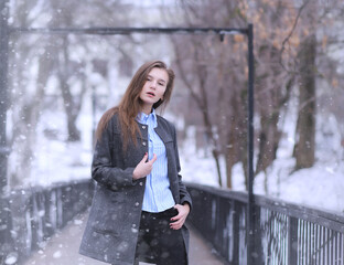 Young girl outdoors in winter. Model girl posing outdoors on a winter day. A festive weekend in the street walking girl.