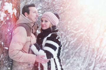 Young family with children are walking in the winter park. Winter walk of parents with children. Walking on a holiday weekend in the winter.