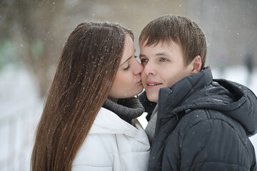 pair of lovers on a date winter afternoon in a snow blizzard