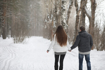pair of lovers on a date winter afternoon in a snow blizzard