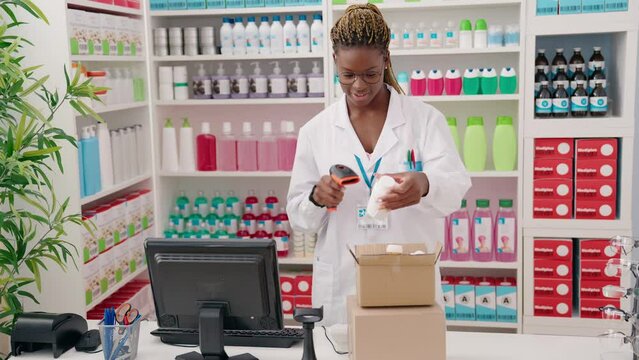 African american woman pharmacist scanning pills bottle at pharmacy