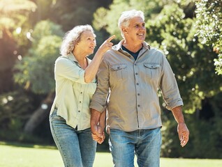 Senior couple, outdoor and conversation in nature park and active on hiking adventure or walk for...