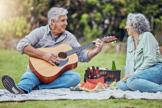 Retirement, Love And Guitar With Couple On Picnic In Park Together For Relax, Summer Or Food. Nature, Wellness And Happy Old Man And Woman Listening To Music In Countryside Field For Health In Spring