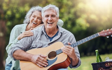 Couple, guitar and picnic with a senior man and woman in nature with a smile and music for fun....