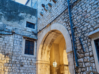 Stone archway. Passageway in Stradun, Placa, the main street of Dubrovnik Old Town. Croatia, Europe